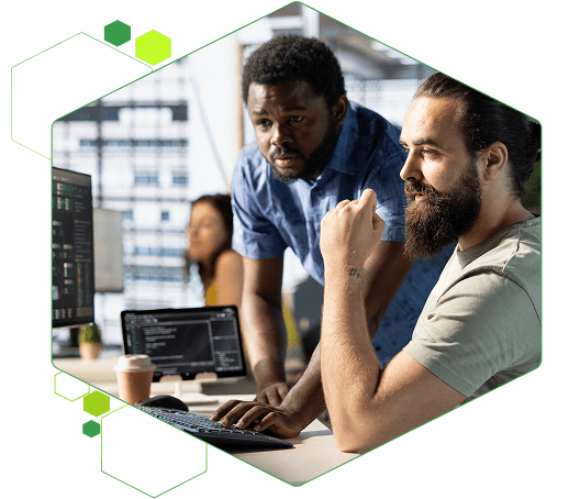 Two colleagues reviewing software together at a desk